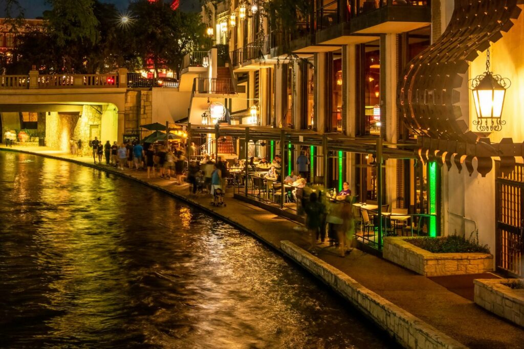 San Antonio River Walk at night with restaurants lit along the river