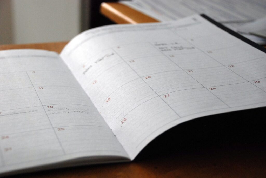 Open monthly planner on a wooden desk